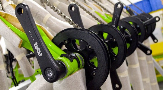 Bespoke crank arms being fitted to a Frog Kids Bike in the factory